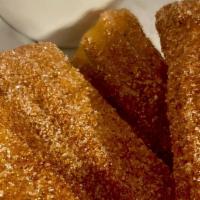 Choco Churros · Dusted in cinnamon sugar with a hazelnut dipping sauce.