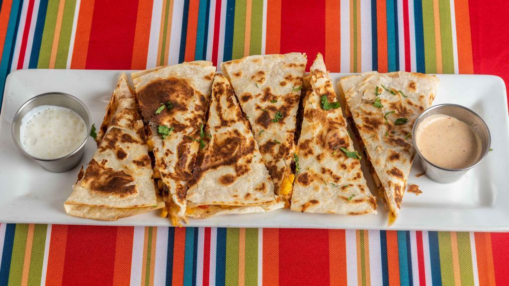 Southwestern Quesadilla · Quesadilla made with filling of your choice, cheese, black beans, corn and pico de gallo . Garnished with cilantro and served with chipotle ranch and sour cream on the side.