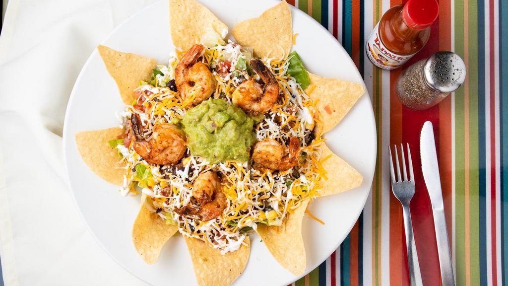 Los Chaparros Salad · Bed of tortilla chips topped with romaine lettuce, black beans, corn, shredded cheese, pico de gallo, salsa, sour cream and guacamole.