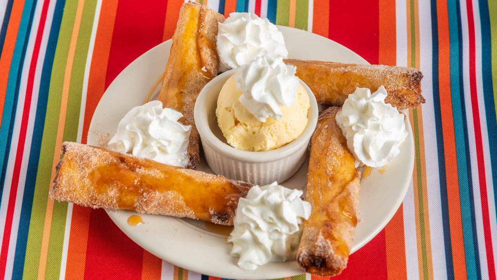 Banana Flautas · Bananas rolled in a crispy flour tortilla with cinnamon and sugar. Served with vanilla ice cream and garnished with caramel and whipped cream.
