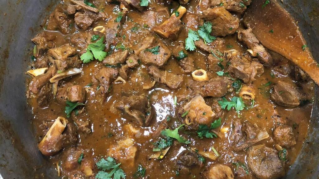 Curry Goat · Cubed goat meat in our famous family curry sauce.