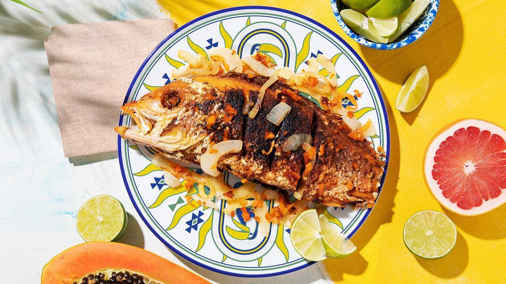 Escovitch · Fried snapper with spicy peppers and onions.