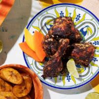 Jerk Chicken Dinner · Chicken thigh marinated in house jerk sauce with your choice of side and drink.