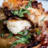 Grilled Octopus  · toped with fresh garlic, peppers, onions, and boiled potatoes