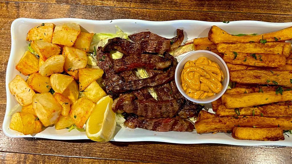 Grilled Top Sirloin With Yucca Sticks And Papas Bravas  (New) · Grilled top sirloin with yucca fires, and chipotle potatoes (papas bravas)