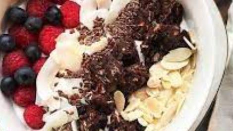 Yum Yum Yogurt Bowl · Acai bowl topped with  greek yogurt, granola, bananas, strawberries, blueberries, and honey.