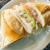 Turkey Sandwich · Served with lettuce, tomatoes, onions, seasoning & house dressing.
