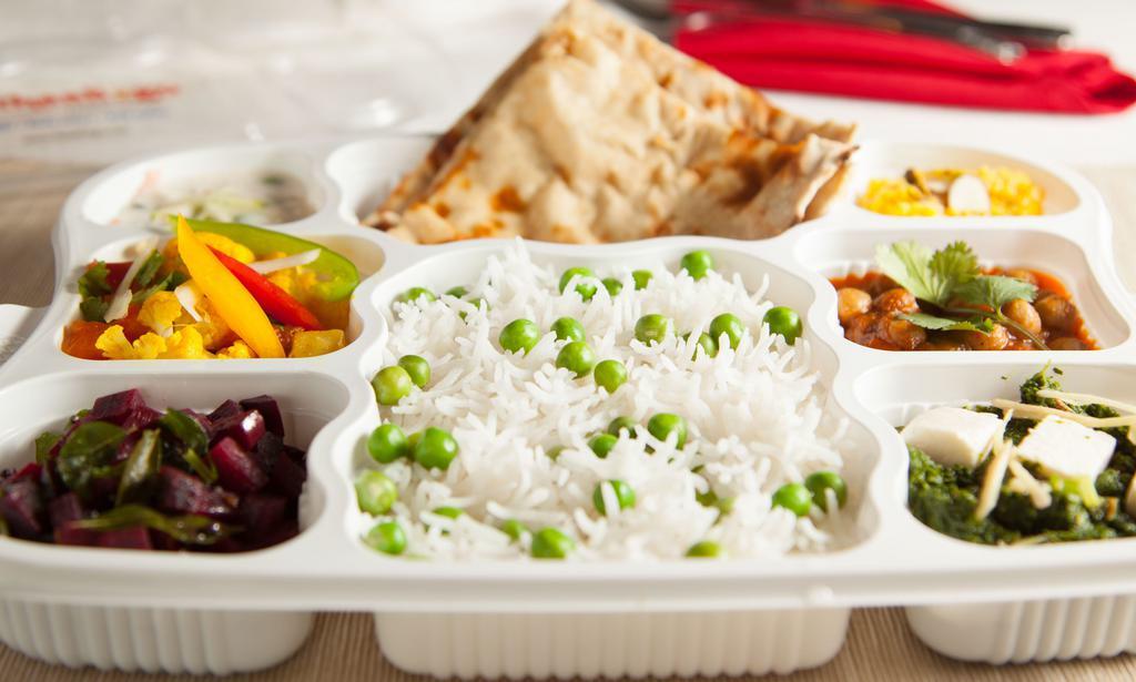 Vegetarian Thaali · Three vegetables, daal, basmati rice, naan/roti, yogurt, dessert.