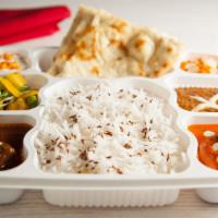 Non-Vegetarian Thaali · Chicken, goat/lamb, vegetable, daal, basmati rice, naan/roti, yogurt, dessert.