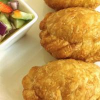 Curry Puff · Crispy puff stuffed with chicken, potato, onion and herbs.