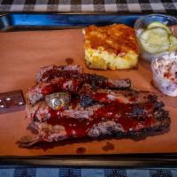 Beef Brisket Platter · Sliced Texas-style beef brisket. Served with coleslaw, pickles, onions, cornbread and a choi...