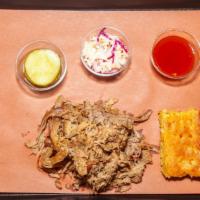 Pulled Pork Platter · Our Carolina style pulled pork. Served with coleslaw, pickles, onions, cornbread and a choic...