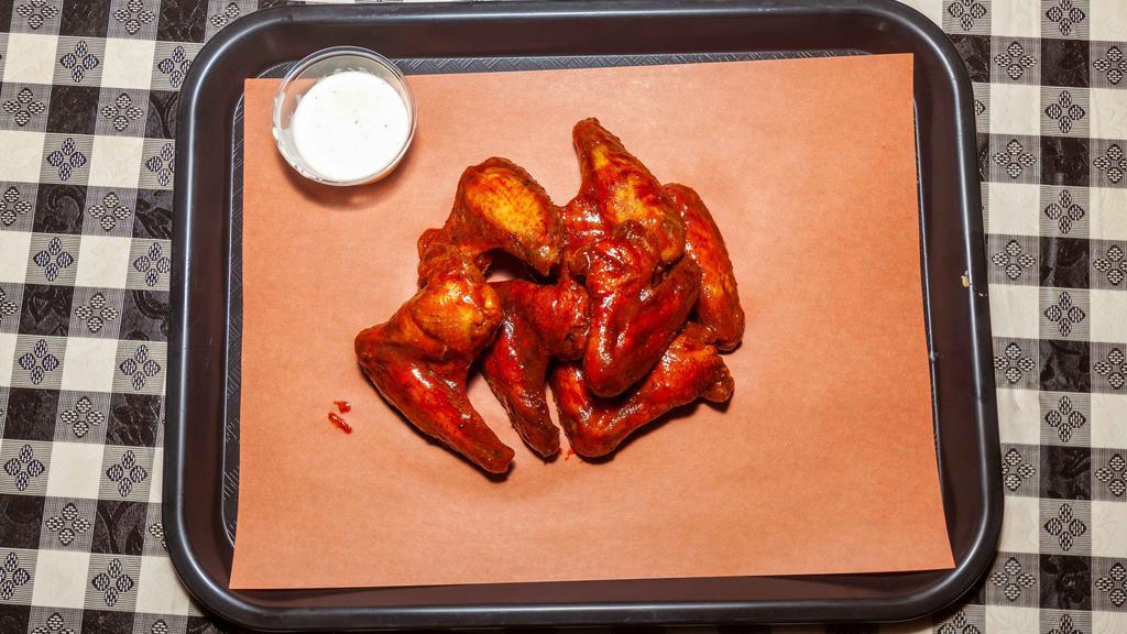 Smoked Hot Wings · 6 Full chicken wings, lightly seasoned with a kick, and slow smoked.