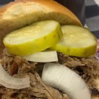 Pulled Pork Sandwich · Carolina style pulled pork.  Served on a roll with coleslaw, pickles, onions, and a choice o...