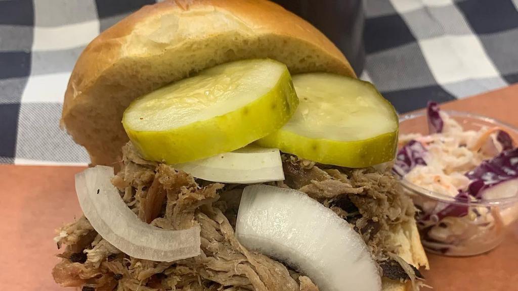 Pulled Pork Sandwich · Carolina style pulled pork.  Served on a roll with coleslaw, pickles, onions, and a choice of BBQ sauce.