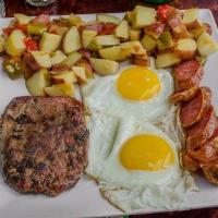 Izu Tudo · Six ounce sirloin steak, one Uruguayan chorizo, eggs, and fries.