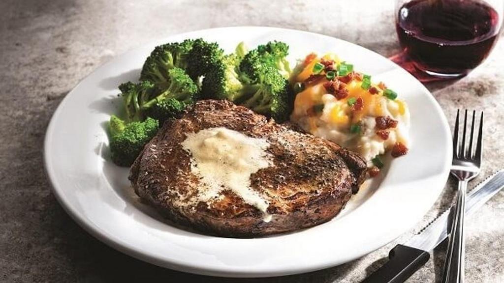 Classic Ribeye* · Marbled, thick-cut steak topped with garlic butter. Served with loaded mashed potatoes (add 350 cal) & steamed broccoli (add 40 cal).