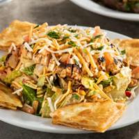 Quesadilla Explosion Salad · Grilled chicken, cheese, tomatoes, corn & black bean salsa, tortilla strips with citrus-bals...