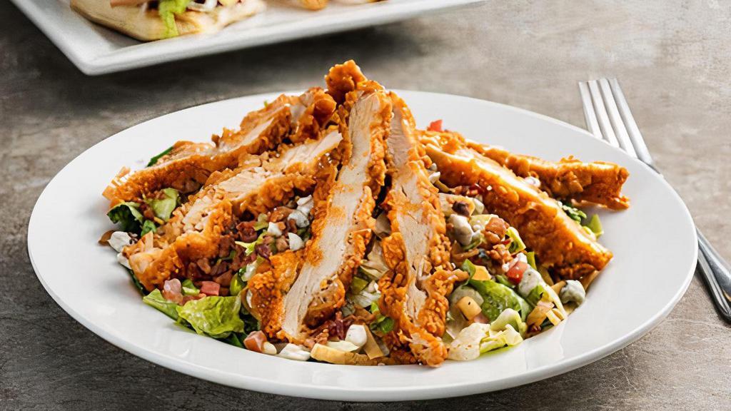 Boneless Buffalo Chicken Salad · Hand-breaded crispy chicken tossed in spicy Buffalo sauce, bacon, bleu cheese crumbles, pico, tortilla strips with house-made ranch.