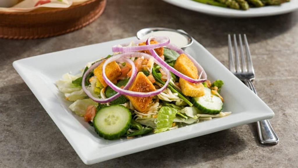 Side House Salad · Tomatoes, red onions, cucumbers, shredded cheese, garlic croutons with your choice of dressing.