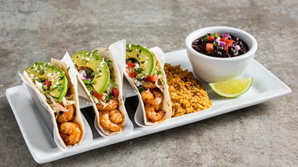 Spicy Shrimp Tacos · Three spicy chile-lime shrimp tacos in flour tortillas with pico, avocado, cilantro, coleslaw queso fresco. Served with Mexican rice & black beans.