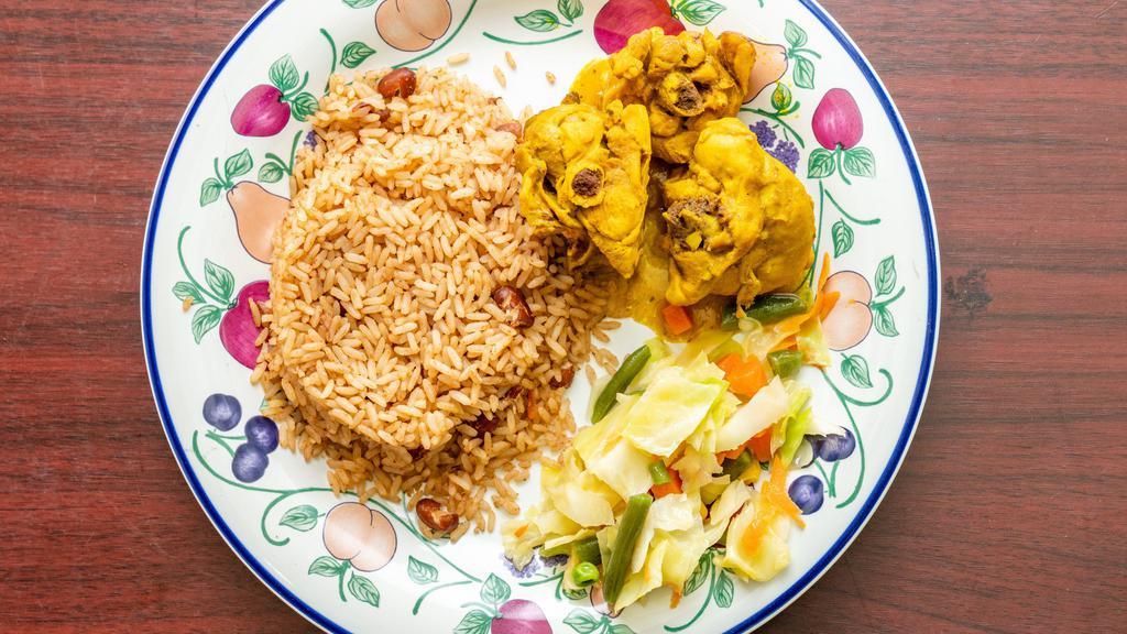 Curry Chicken · Served with plantains, white rice or peas and vegetables.