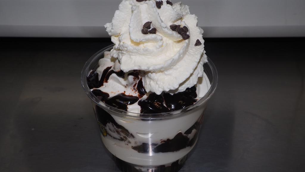 Hot Fudge Brownie · Vanilla Ice Cream sandwiched
between warm fudge brownies and hot fudge. Topped
with homemade whipped cream and chocolate chips