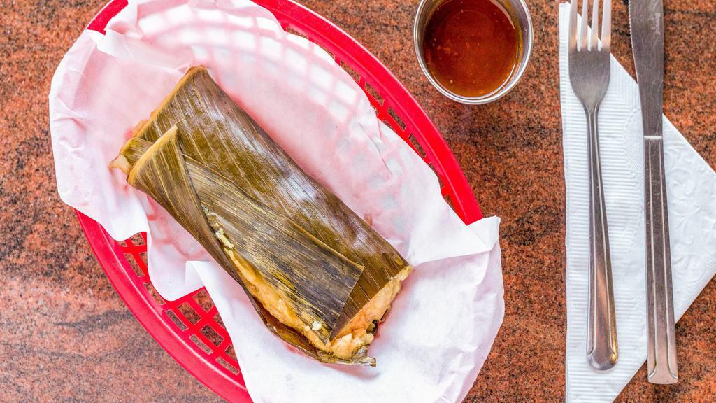 Tamales Salvadorenos · Steamed corn mix tamale stuffed with chicken, potatoes, garbanzo beans and rice. Comes wrapped in a banana leaf.
