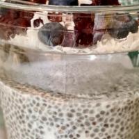 Chia Seed Pudding · Coconut water and milk chia pudding with flaked coconut, blueberries and cacao nibs.