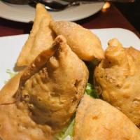 Meat Samosa · Crispy turn over stuffed with spiced ground lamb meat And peas.