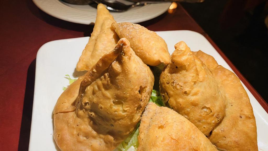 Meat Samosa · Crispy turn over stuffed with spiced ground lamb meat And peas.