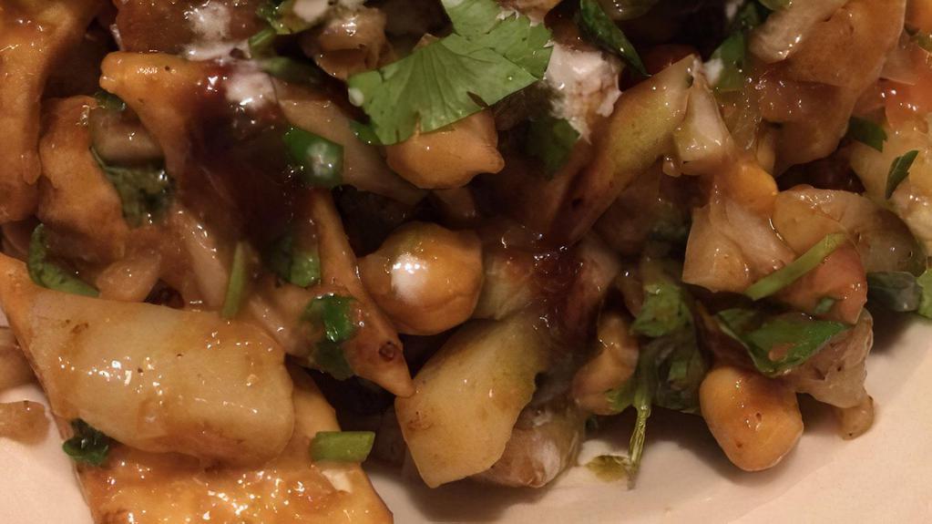 Papdi Chaat · Wheat crisp, diced potatoes, chopped onions, Yogurt, tamarind chutney and spices.