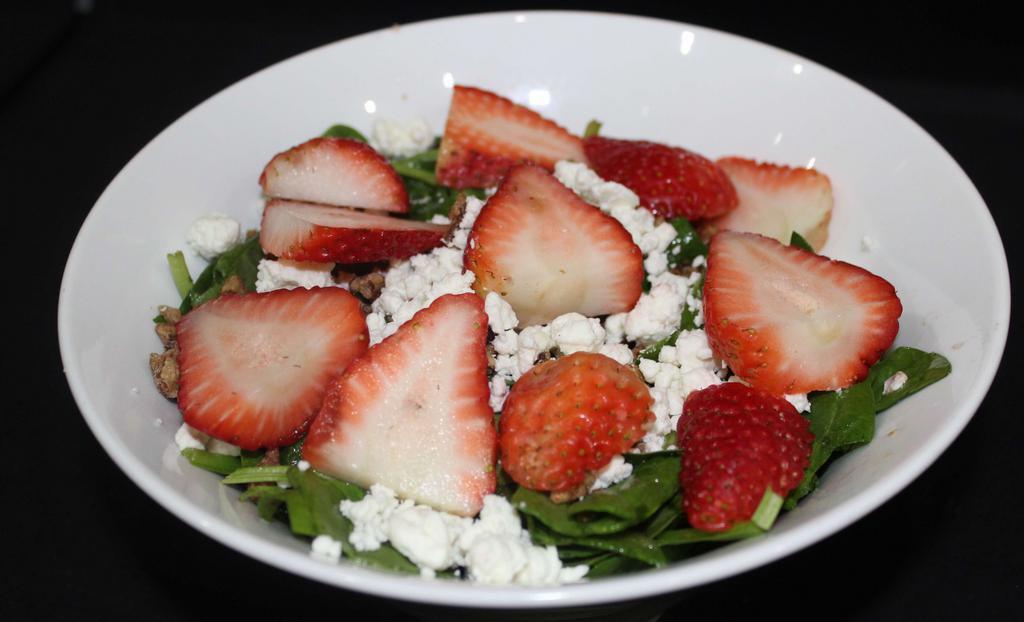 Strawberry And Goat Cheese Salad · Fresh spinach, strawberries, goat cheese and candied pecans tossed in housemade balsamic vinaigrette.