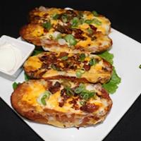 Crispy Potato Skins · Gluten-free. Melted cheese, bacon, green onions, and sour cream.