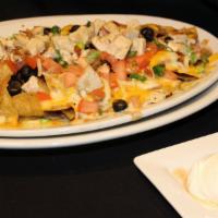 Maggie’S Nacho Platter · Gluten-Free. Tortilla chips, cheese, pinto beans, scallions, tomatoes, black olives, sour cr...