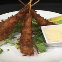 Crispy Coconut Shrimp · Jumbo shrimp, battered, rolled in coconut, and lightly fried. Served with piña colada dippin...