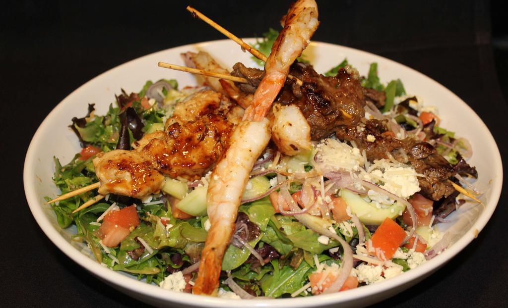Mixed Grill Salad · Certified Angus Beef® steak, grilled all-natural free-range chicken, and grilled shrimp, marinated in a pan Asian sesame glaze. Served on top of mixed greens tossed in a special creamy housemade vinaigrette with crumbled Bleu cheese, Asiago, tomato and red onions.