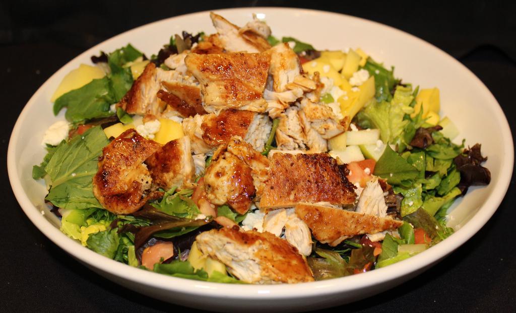 Walnut Chicken Salad · Grilled all-natural free-range chicken breast with a pan Asian sesame glaze tossed with walnuts, apples, tomato, mango, Feta cheese and mixed greens in a light zinfandel vinaigrette.