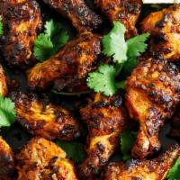 Tandoori Chicken Wings Swings · Chicken wings marinated in spiced yogurt and grilled in tandoori oven. Served with house chu...