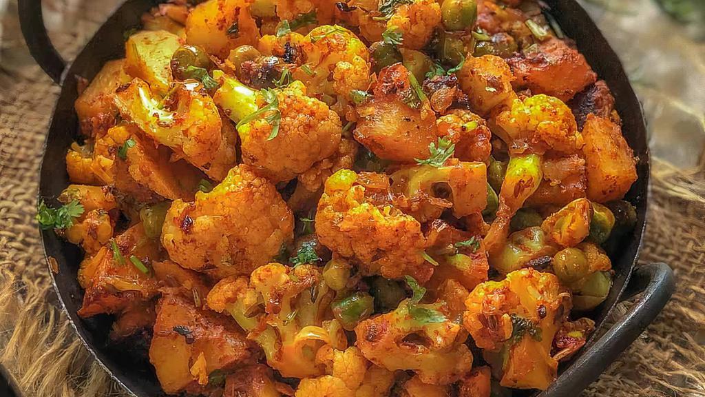 Aloo Mutter Gobi Matter · Cauliflower with potatoes cooked with fresh ginger, onion, spices, and green peas.