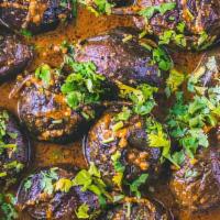 Classic Baby Eggplant Masala · Roasted whole baby eggplant with spices and simmered in a sesame coconut sauce.