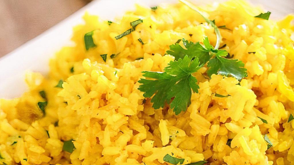 Yellow Rice · Lemon flavored basmati rice with curry leaves and mustard seeds.