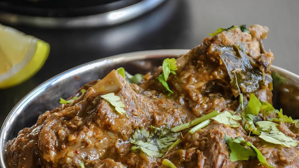 Lamb Vindaloo Love · Lamb cooked in fiery tangy sauce vinegar mixed with cubes of potatoes.