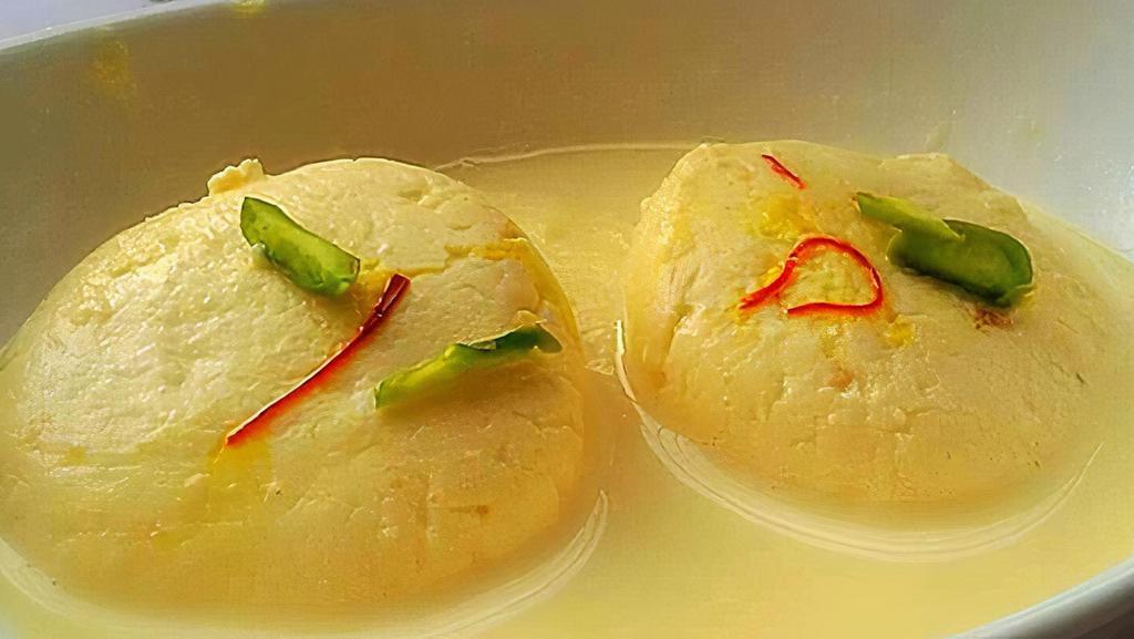 Rasmalai · Homemade spongy cheese patties dipped in cardamom flavored milk.
