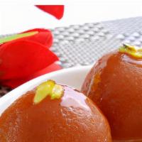 Gulab Jamun · Homemade cheese rounds and evaporated milk simmered in syrup flavored with rose water.