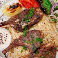Lamb Chops · Served with rice grilled tomato onions and parsley.