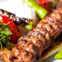 Adana Kebab (Mild Spicy) · Beef and Lamb mixed ground meat marinated with mild spices comes with  rice and salad.