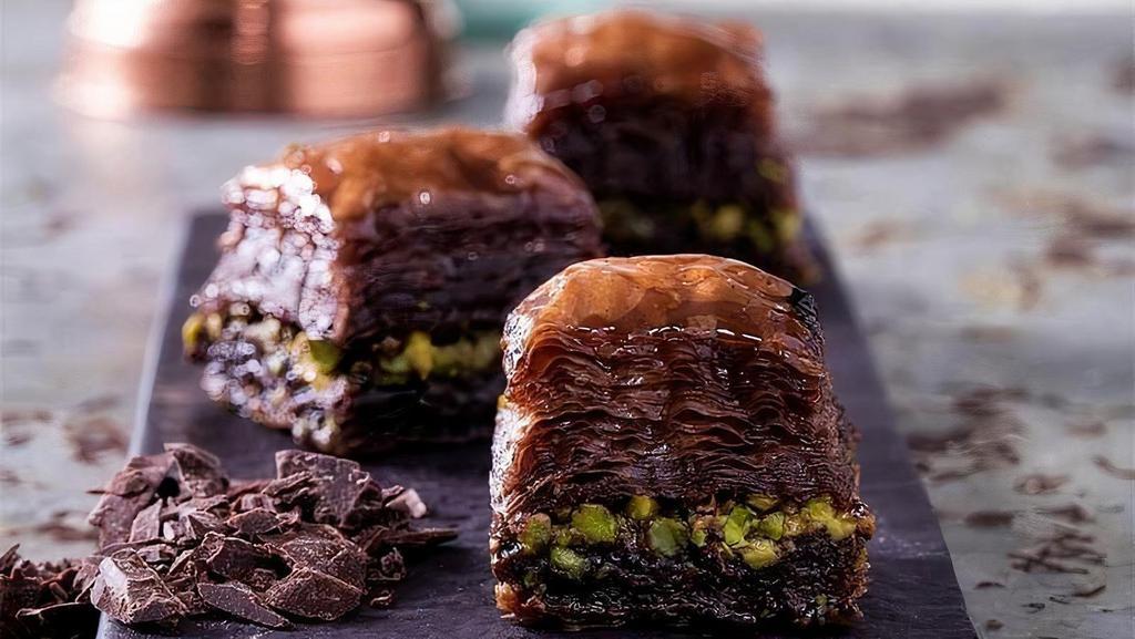 Handmade Chocolate Baklava · Baklava is a very known and preferred dessert in the whole world. Handmade chocolate pistachio baklava is a dessert made from layers of filo pastry, filled with pistachio and chocolate aroma and sweetened with syrup. (2pack) or (4Pack)