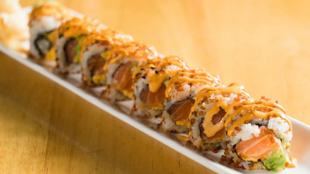 Manhattan Roll · Spicy salmon, crunch, mango, and avocado inside with crunchy rice and sesame seed outside.