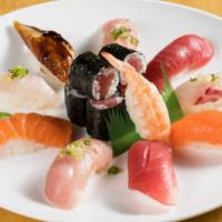 Sushi Deluxe · 2 bigeye tuna, 2 yellowtail, 2 salmon rolls, 2 white fish rolls, 1 eel roll, and 1 shrimp ro...